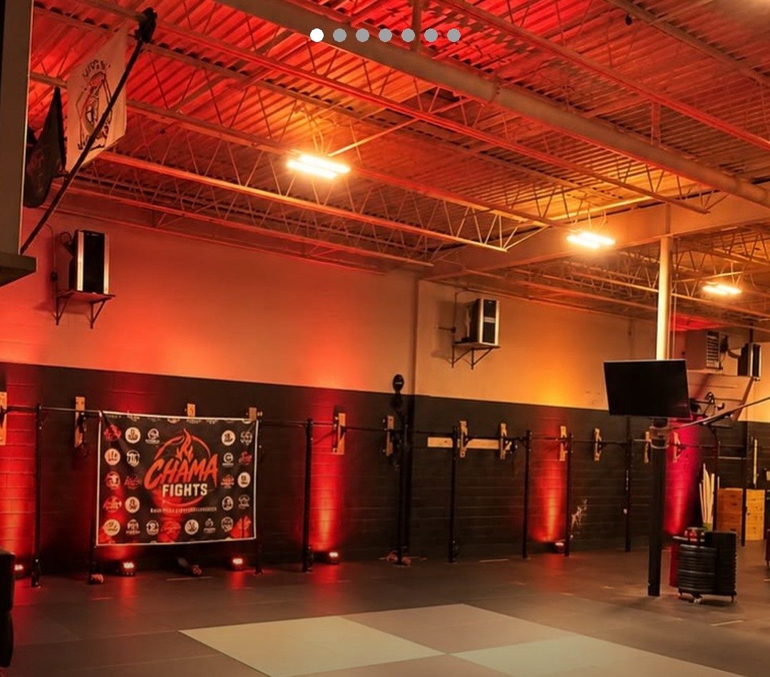 The Chama Fights stage and banner under red lights at the first event