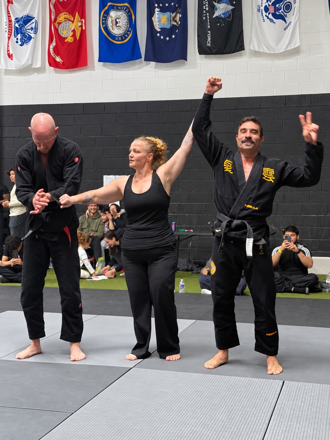A winner's hand raised at Chama Fights 1 while his opponent applauds